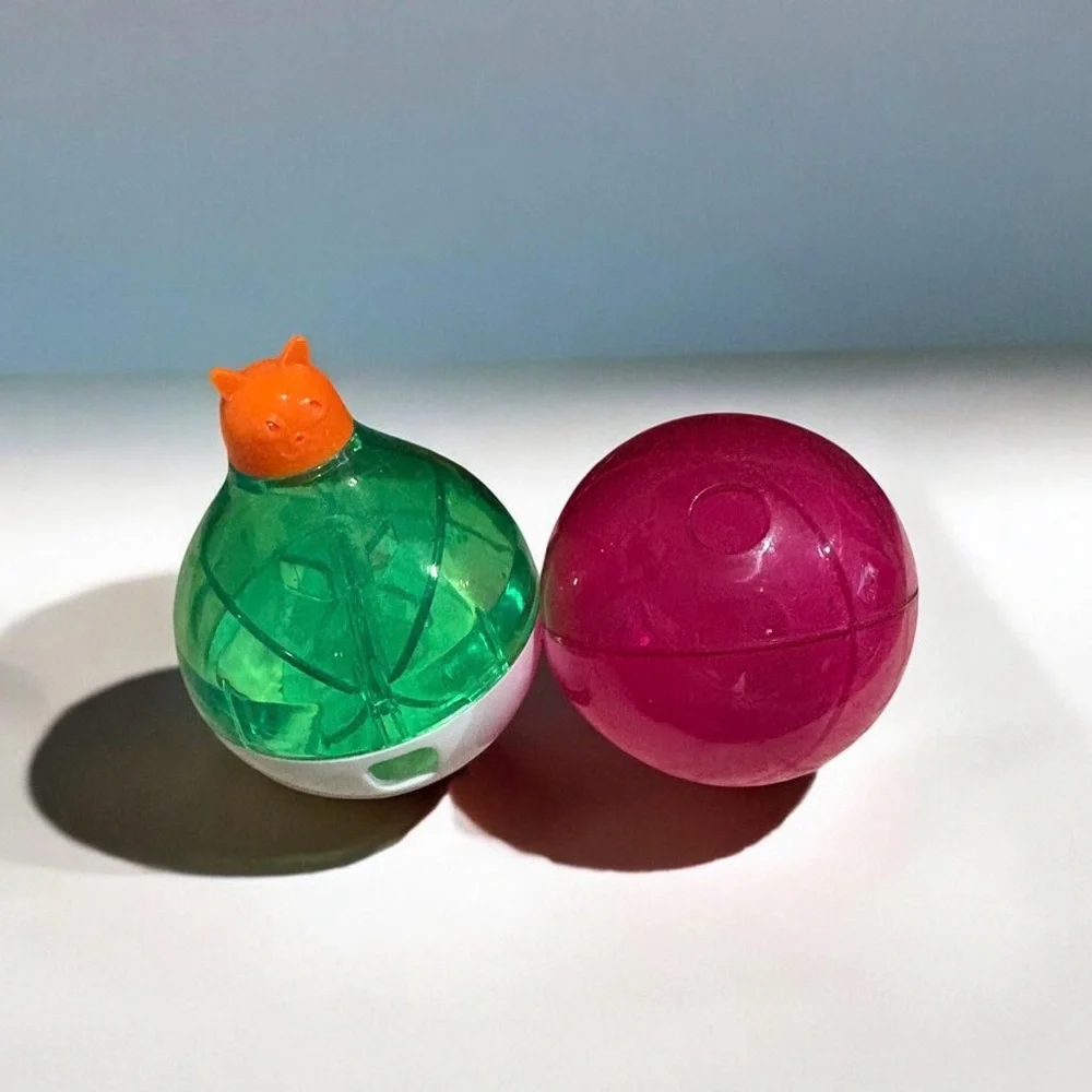 Two Green & Pink Spinning Treat Capsule Dispensers for Cats